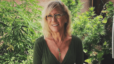 Susan Soares Author & cannabis advocate sits among her cannabis plants